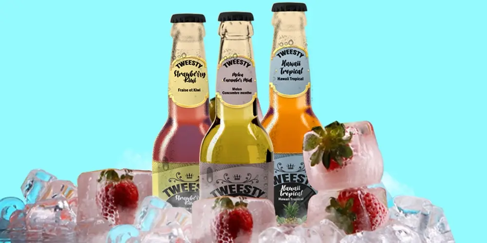 Refreshing TWEESTY beverage collection featuring Mango & Orange, Mojito, and Strawberry flavours, artistically presented on a bed of ice to emphasize coolness and freshness.